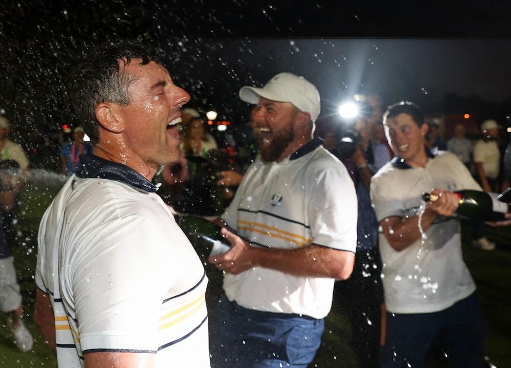 Shane Lowry sprays Rory McIlroy of Team Europe Photo by Richard HEATHCOTE / GETTY IMAGES NORTH AMERICA / Getty Images via AFP