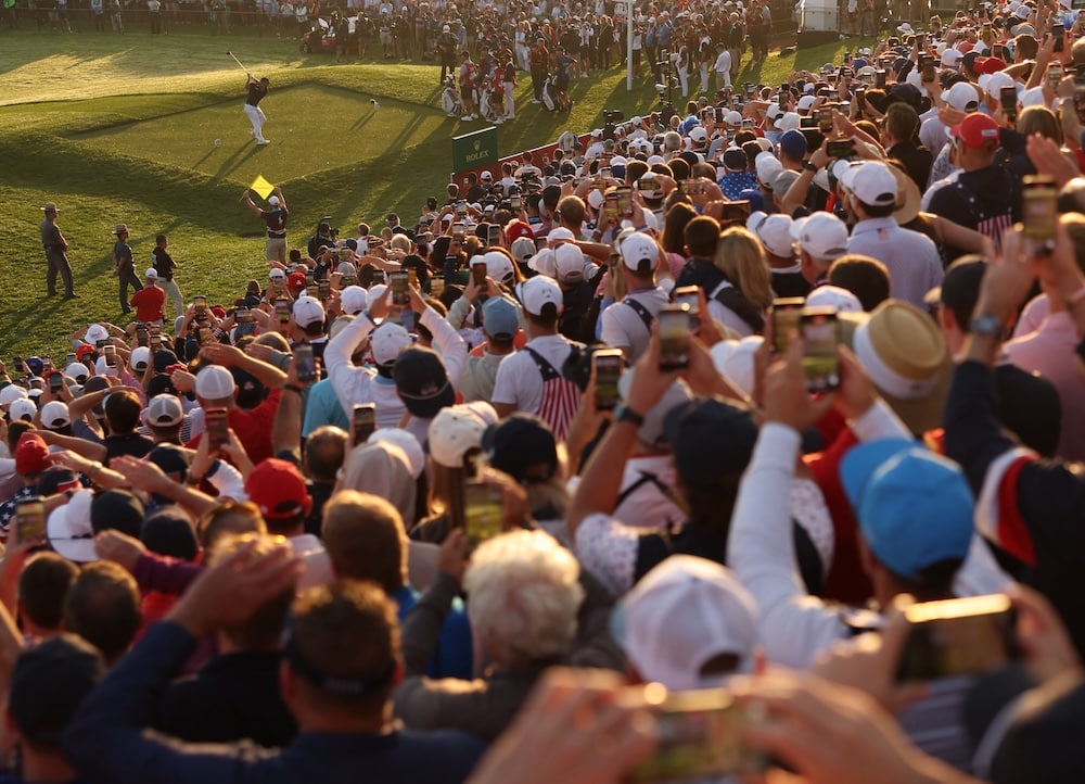 Bryson DeChambeau of Team United States hits his tee shot on the first hole supporter fan Photo by Maddie Meyer/PGA of America
